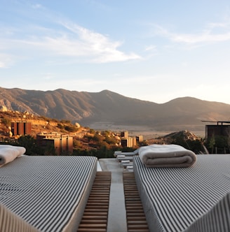 sunloungers fronting buildings near mountain