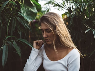 woman near green leafed plants onlyfans