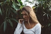 woman near green leafed plants