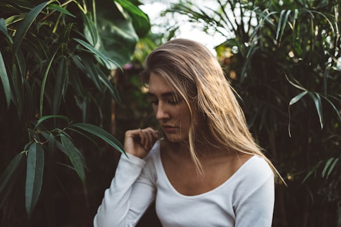 woman near green leafed plants onlyfans