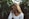 woman near green leafed plants