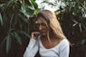 woman near green leafed plants