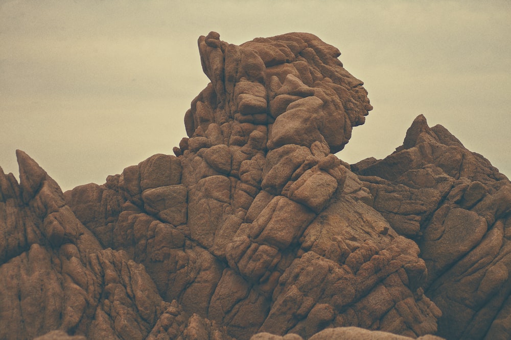 brown rocky mountain under cloudy sky