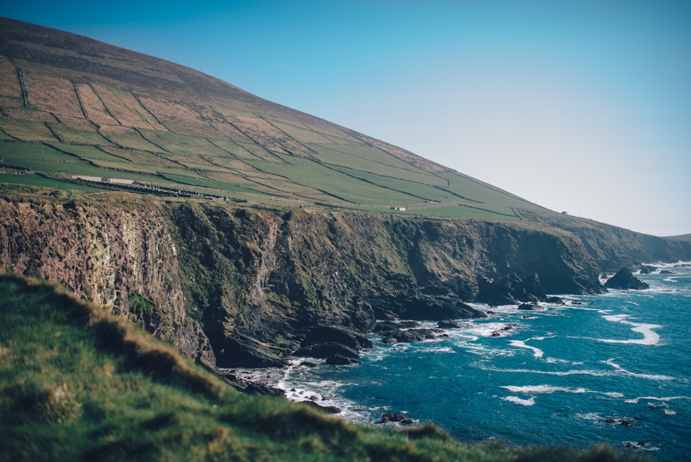 landscape photography of cliff under blue sky