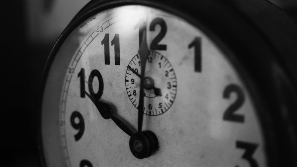 grayscale photography of pocket watch