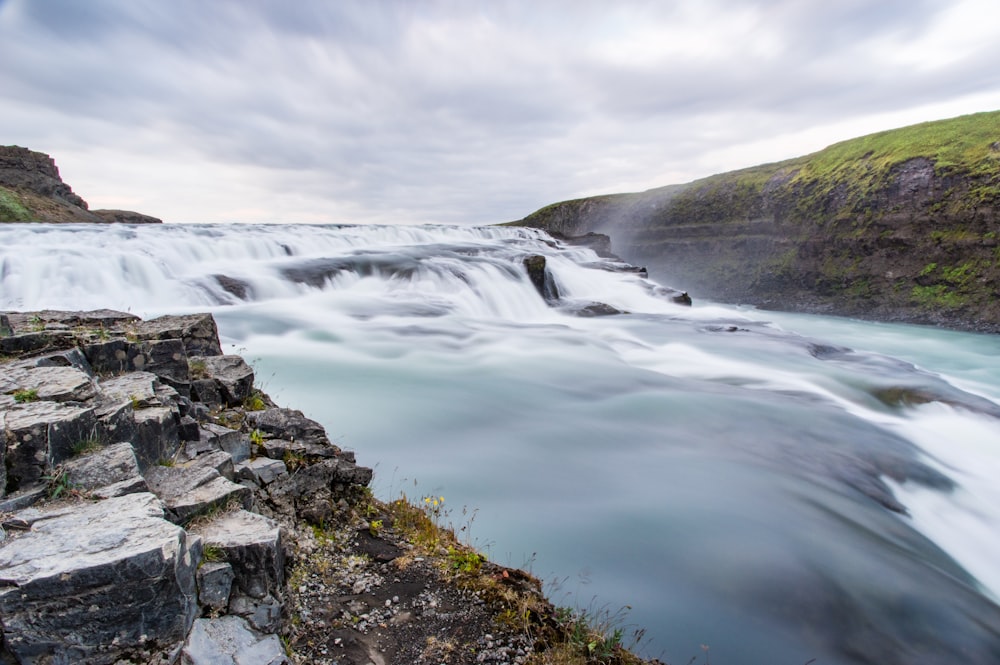 waterfalls under cloudy day