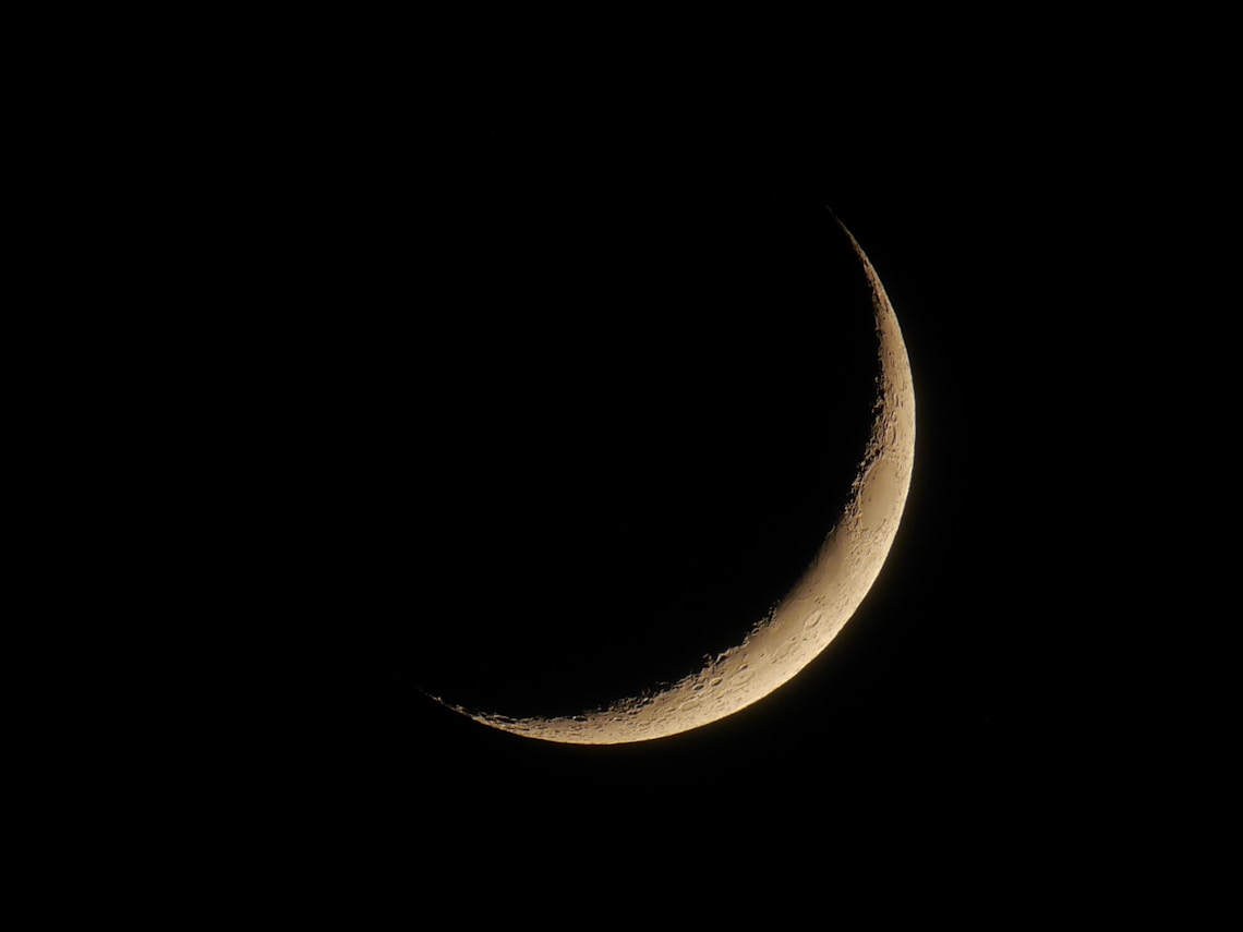 crescent moon against black sky