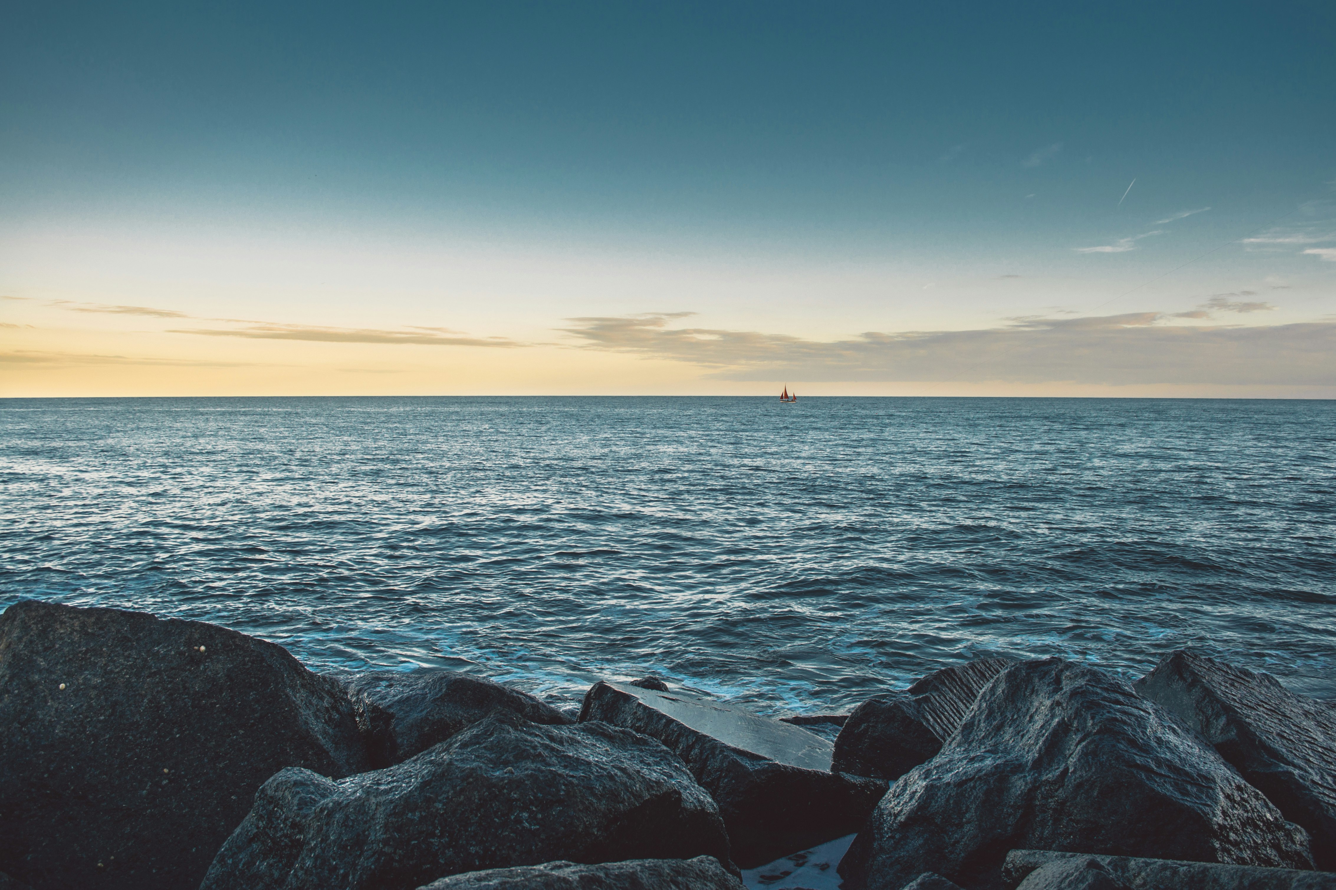 rock formation beside ocean during daytime