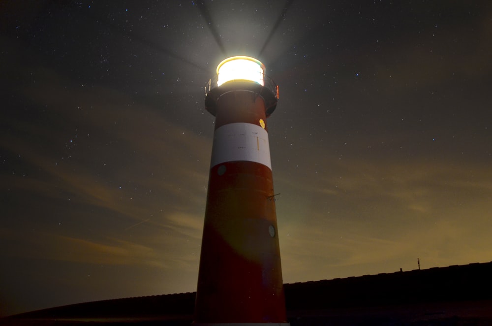 low angle view of red and white lighthouse