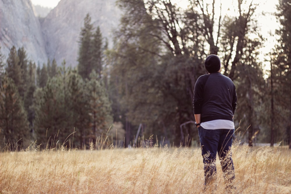 person wearing black beanie and raglan shirt while being photograph during day time