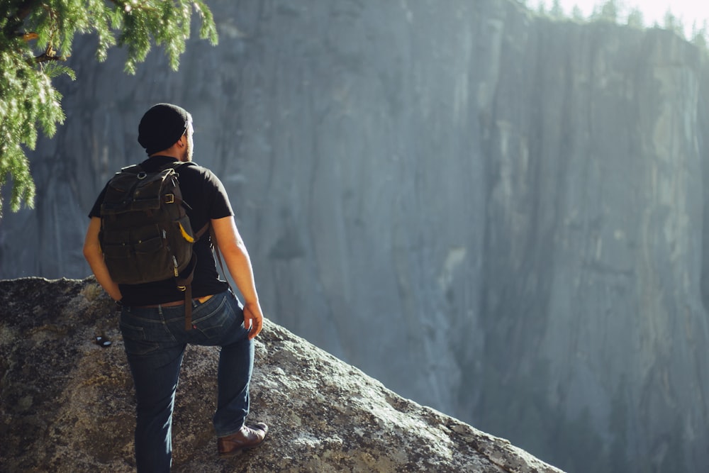 man standing on gray stone