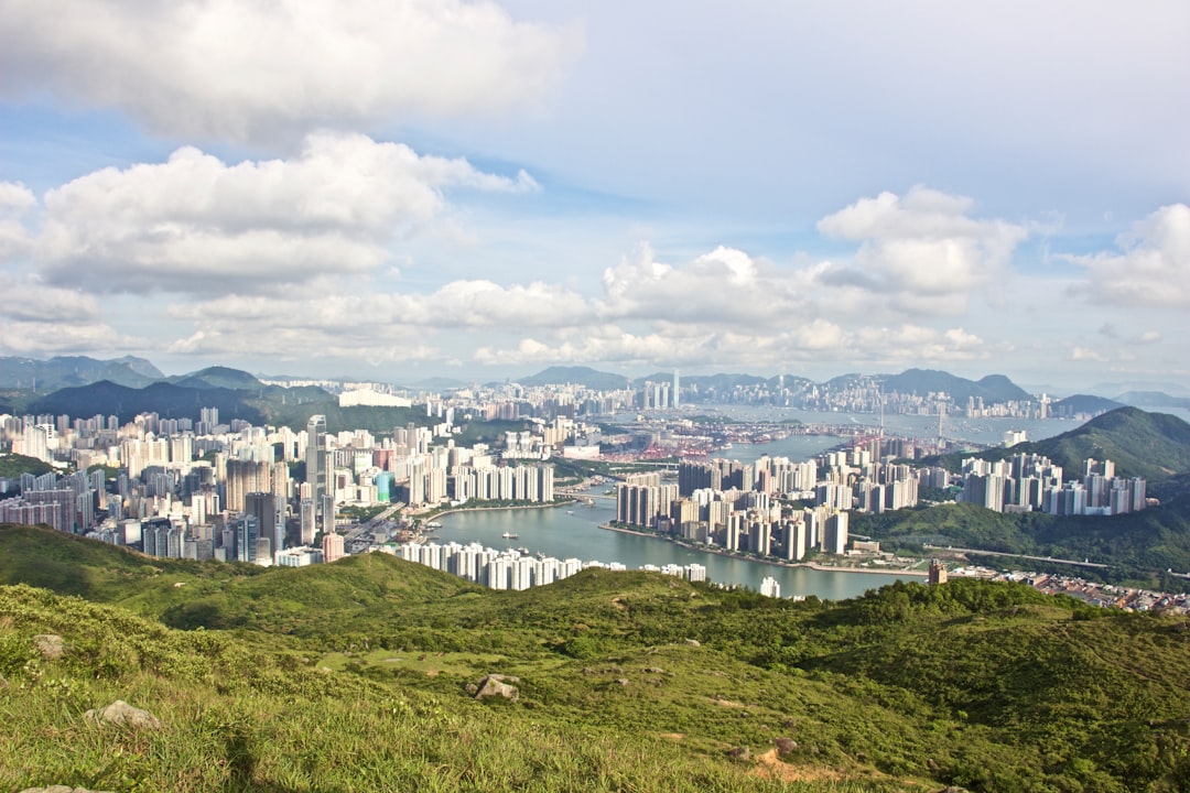 city under clouds near mountain at daytime