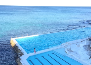 person walking beside pool