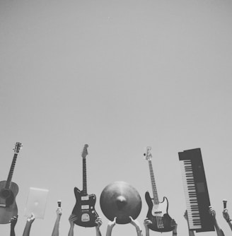 grayscale photo of people holding assorted music instruments