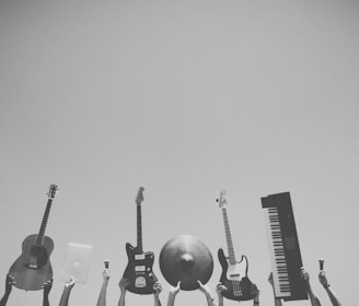 grayscale photo of people holding assorted music instruments