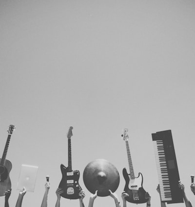 grayscale photo of people holding assorted music instruments