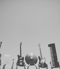 grayscale photo of people holding assorted music instruments