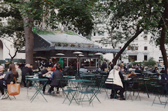 Vibrant street view of grünfeuer’s bustling outdoor seating area filled with happy customers.