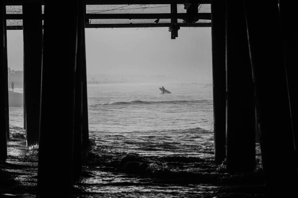 grayscale photo of dock and body of water