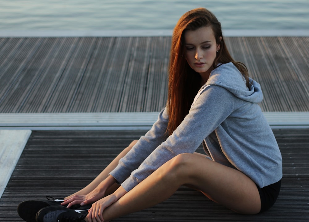 women's gray hoodie doing yoga