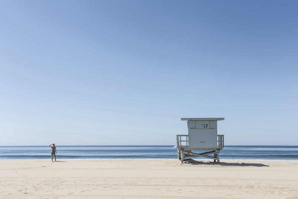 person standing near lifeguard house