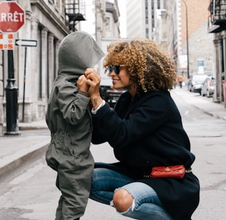 woman holding kid at the street