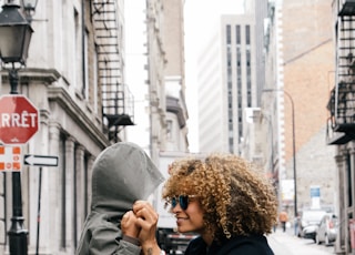 woman holding kid at the street