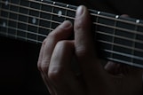 person using guitar