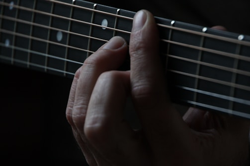person using guitar