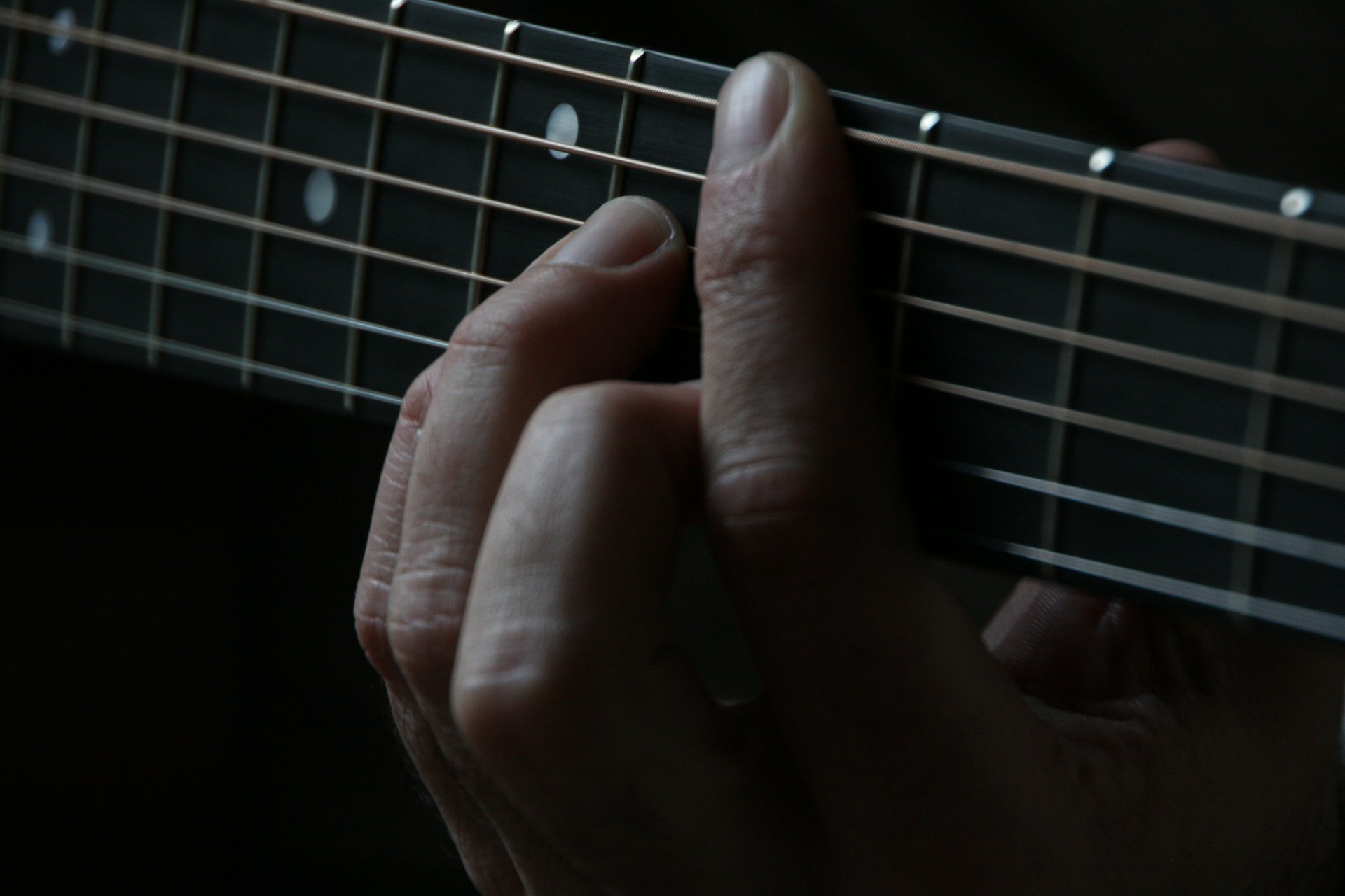 person using guitar