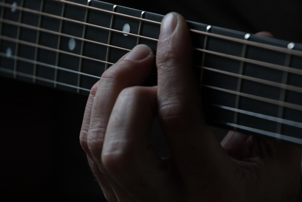 person using guitar