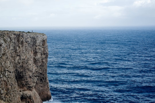 mountain cliff surrounded by body of water during daytime in Cape St. Vincent Portugal