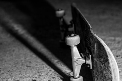 A close-up photo of a Trust Skateboard shape with vibrant graphics on a wooden floor.
