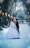 A couple dressed in formal wedding attire shares a kiss in a snow-covered park. The scene is framed by tall trees with bare branches, and a row of glowing streetlamps lines the path. Snow gently falls around them, adding a magical touch to the scene.
