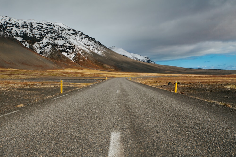 gray asphalt road under cloudy sky