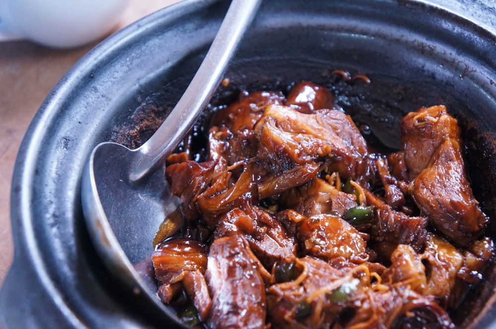 meat with sauce in black bowl