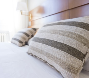 gray and black throw pillow on bed