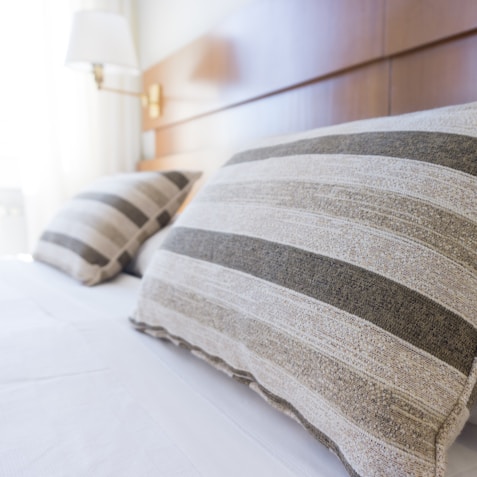 gray and black throw pillow on bed