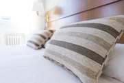 gray and black throw pillow on bed
