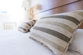 gray and black throw pillow on bed