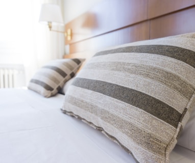 gray and black throw pillow on bed