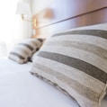 gray and black throw pillow on bed