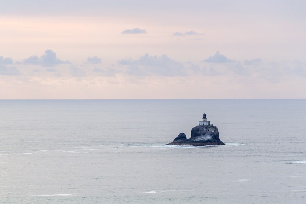 building on rocky cliff surrounded by the sea