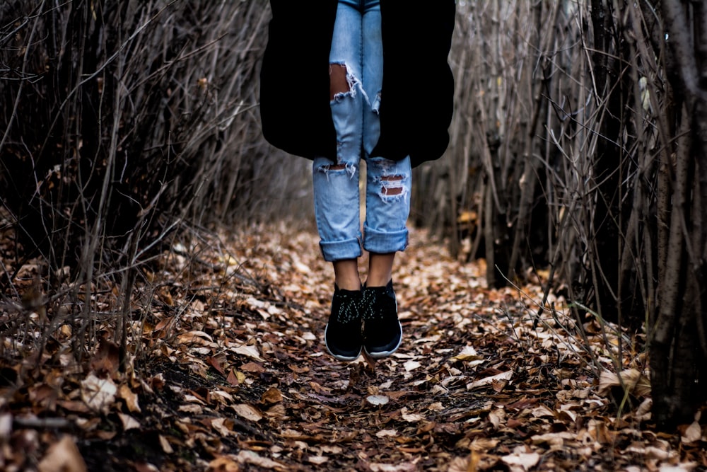 person standing on dried leaves