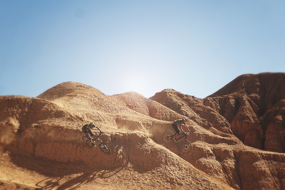 photo of bikers on mountain