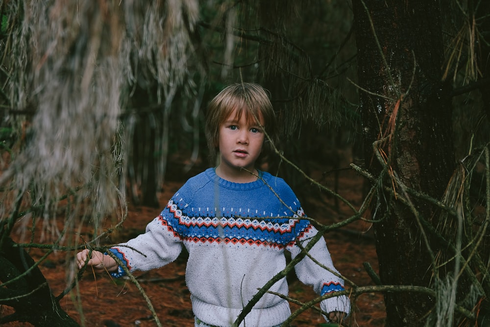 boy standing near tree