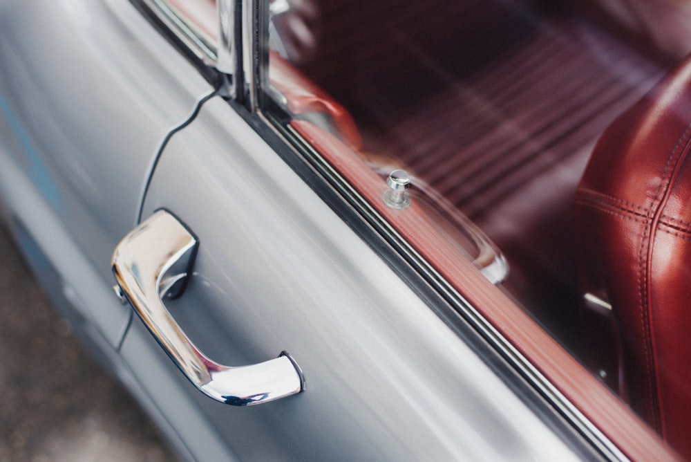 selective focus photo of gray vehicle door handle