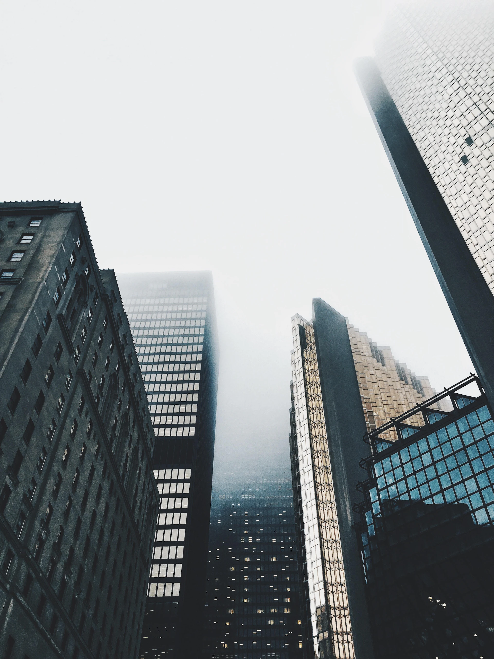 High-rise buildings rising through fog