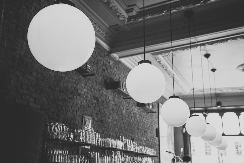 grayscale photo of pendant lights