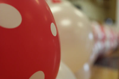 Close-up of colorful balloons and clown props on a white background, highlighting a festive atmosphere.